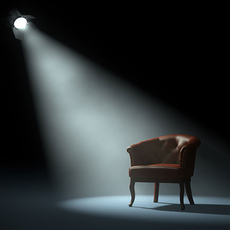 an empty chair with a spotlight